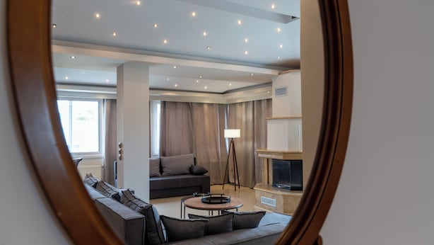 A modern living room with a sofa, a coffee table, and a fireplace.