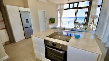 Panoramic Penthouse | Private kitchen | Full-sized fridge, microwave, oven, stovetop