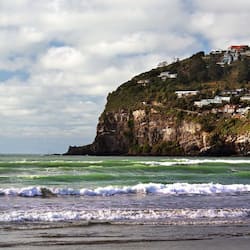 Beach nearby, white sand, beach towels, windsurfing