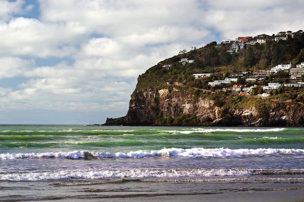 Beach nearby, white sand, beach towels, windsurfing
