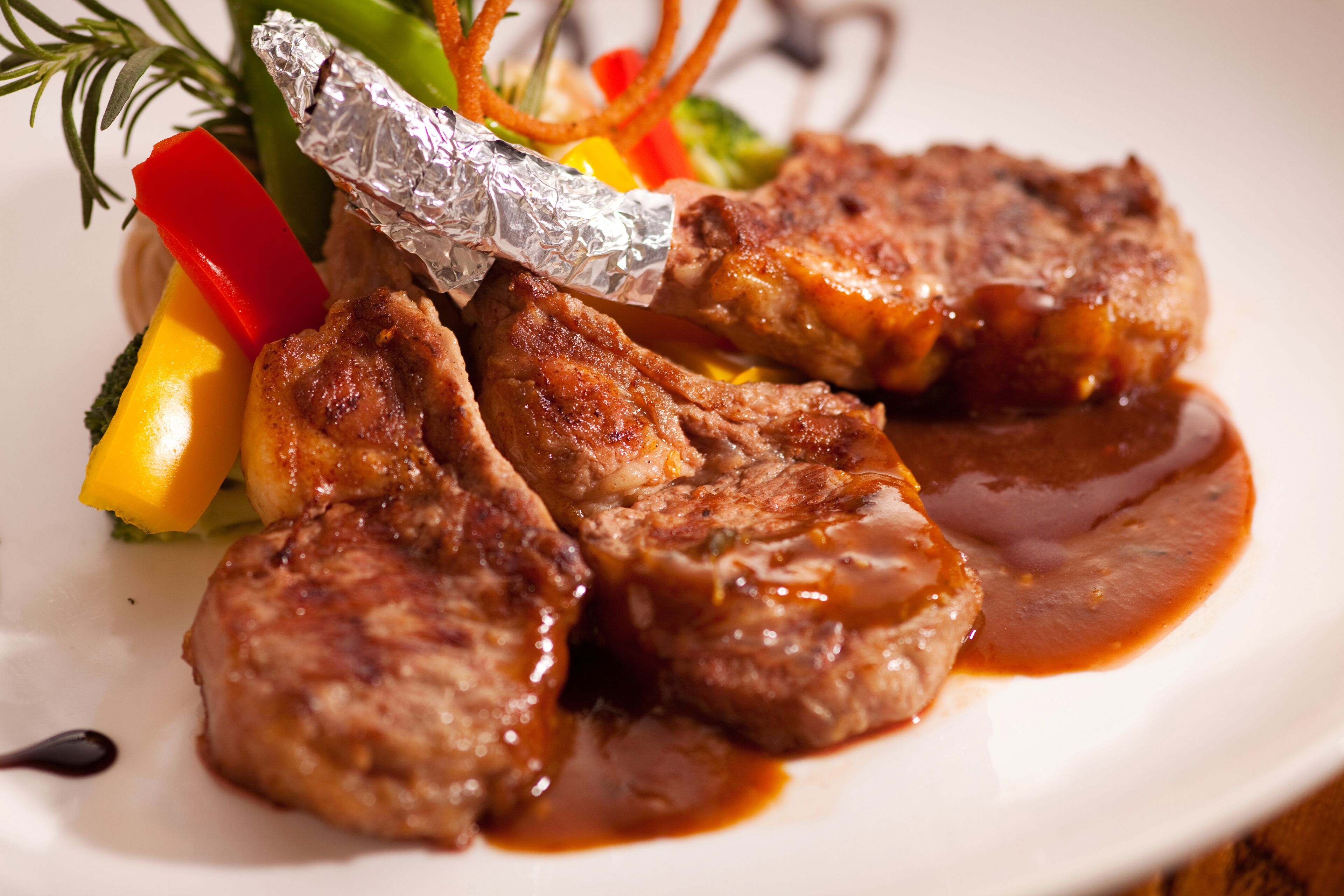 A plate of food with grilled meat and vegetables.