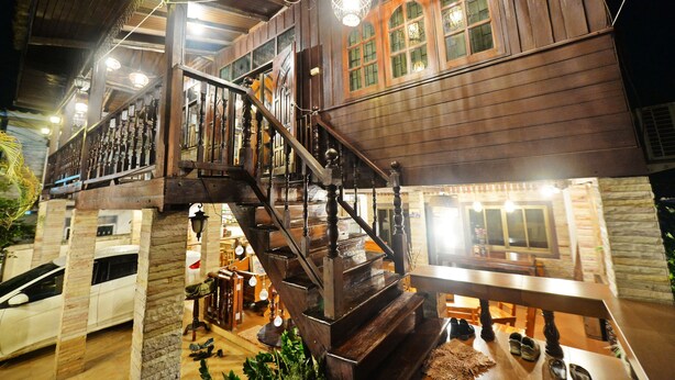 A wooden building with a staircase and multiple windows. - Huan Kawin Est.58 Lanna Home & Collection - Campus Accommodation (Chiang Rai)