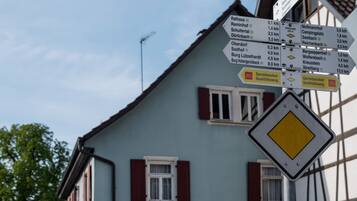 A directional signpost in front of a building with a sign for 'Landgasthof Ochsen Hotel - Restaurant'.