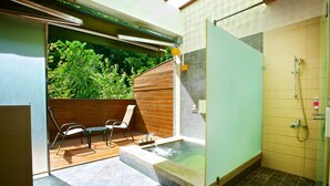 A spa area with a hot tub, seating, and a shower. - Hsinchu Bali Forest Hot Spring Resort (Jianshi)