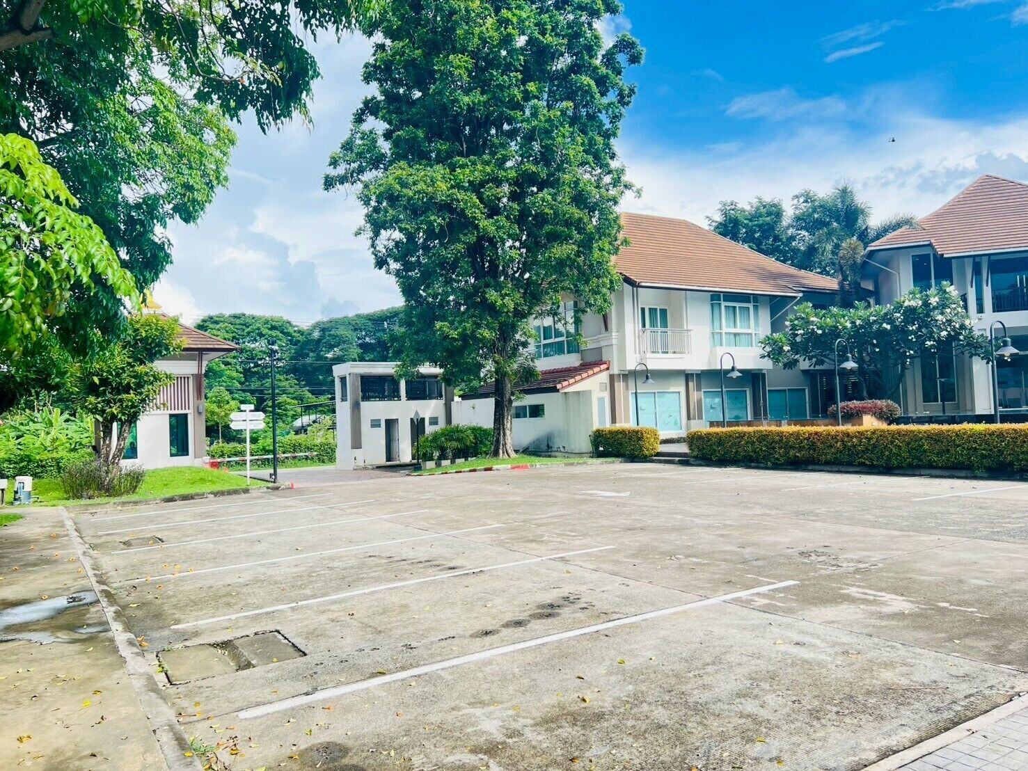 A parking lot with a building in the background.
