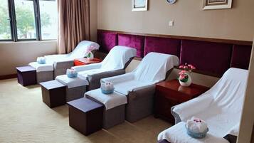 Relax in comfort with our massage therapy beds, each equipped with a pillow and personal table.