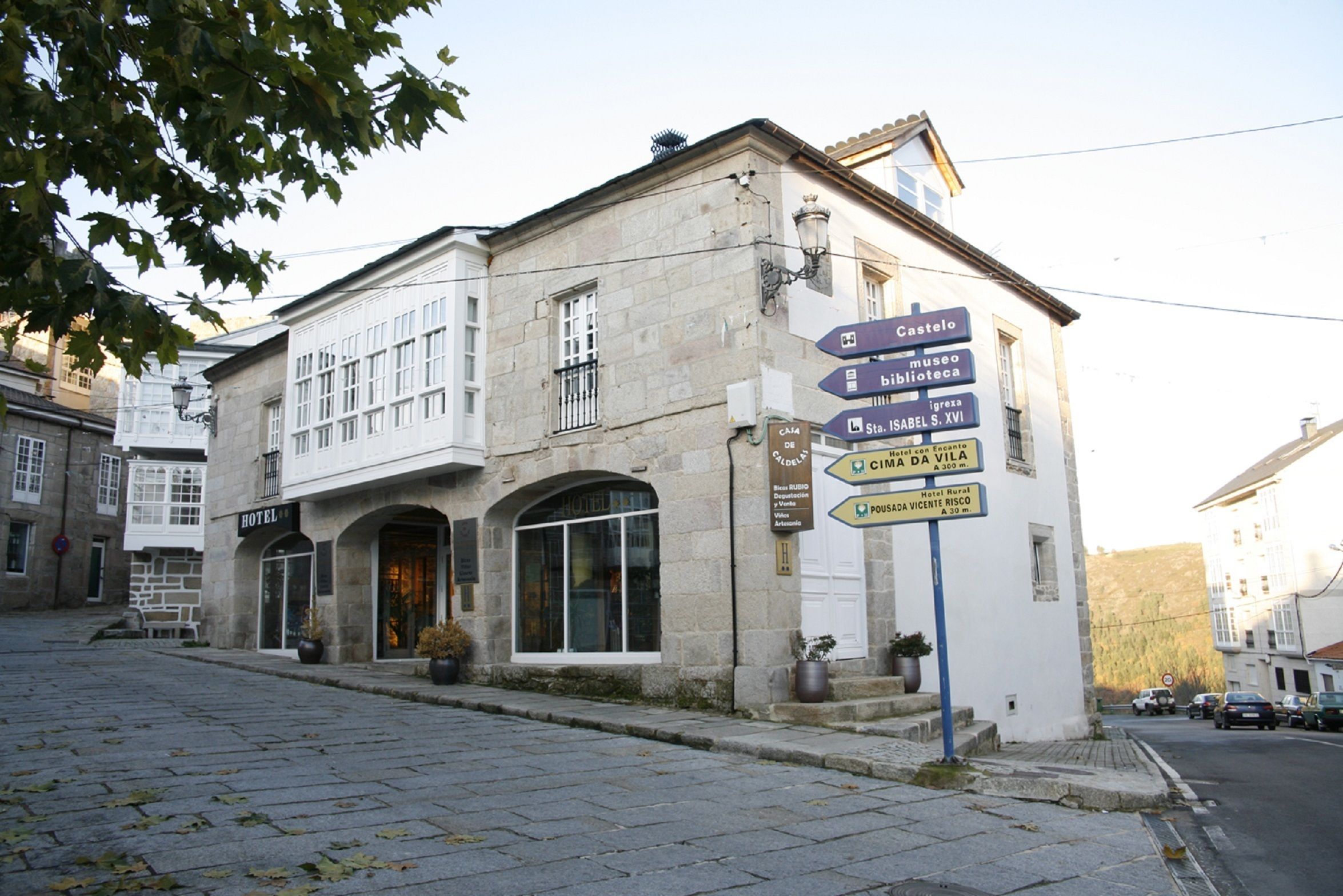 A historic building with a sign indicating a hotel, a museum, a library, and a church.
