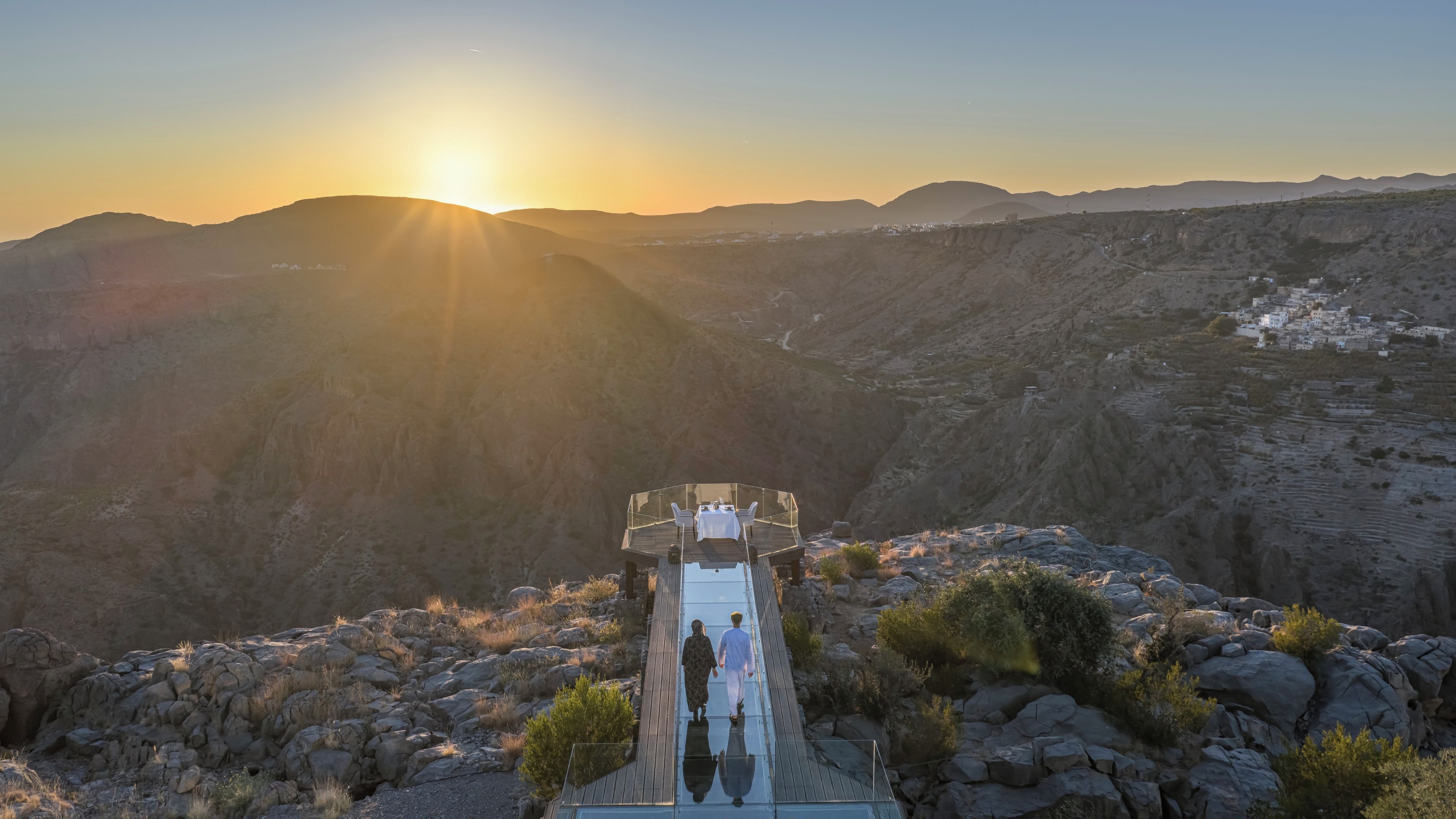 Un punto de vista elevado con vistas a un valle al atardecer.