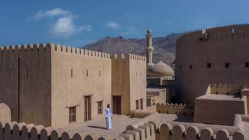 A fortress-like structure with a central tower and a dome, surrounded by walls with battlements.