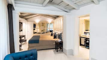 A modern hotel room with a bed, bedside table, and a view into the bathroom.