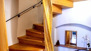 A spiral staircase with wooden steps and a glass railing. - Zum Handtuch (Bautzen)