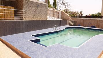 Outdoor pool, pool umbrellas, sun loungers