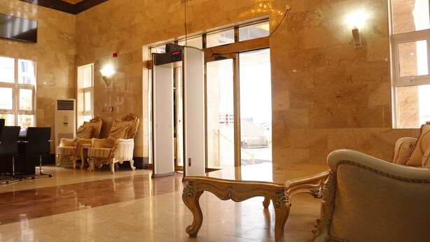 A lobby with marble flooring, a reception desk, and two ornate chairs. - Barca-Liga Hotels (Abuja)