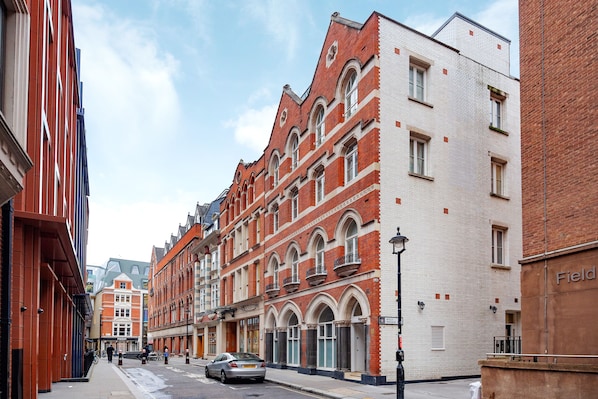 A street view of a building with a red brick facade, large windows, and a sign that reads "Field".