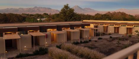 A modern building with multiple rooms, a courtyard, and a mountain view.
