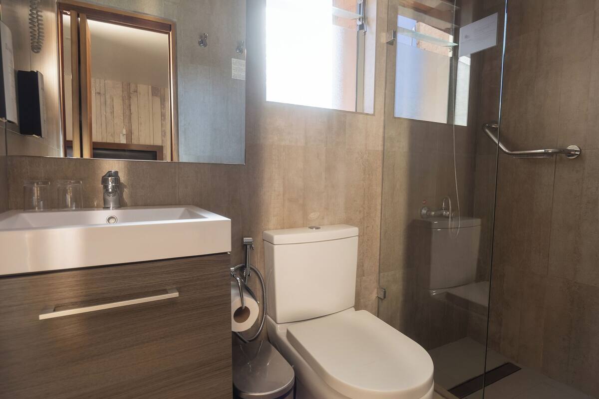 standard double room, 1 king bed | bathroom | shower, eco-friendly toiletries, towels