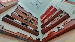A room with multiple wooden shelves displaying various items. - Azcami Boutique Hotel (Puebla)