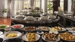 A buffet with various food items and a coffee station.
