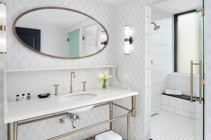 A modern bathroom with a double sink vanity, a large mirror, and a shower area. - Hotel LeVeque, Autograph Collection (Columbus)