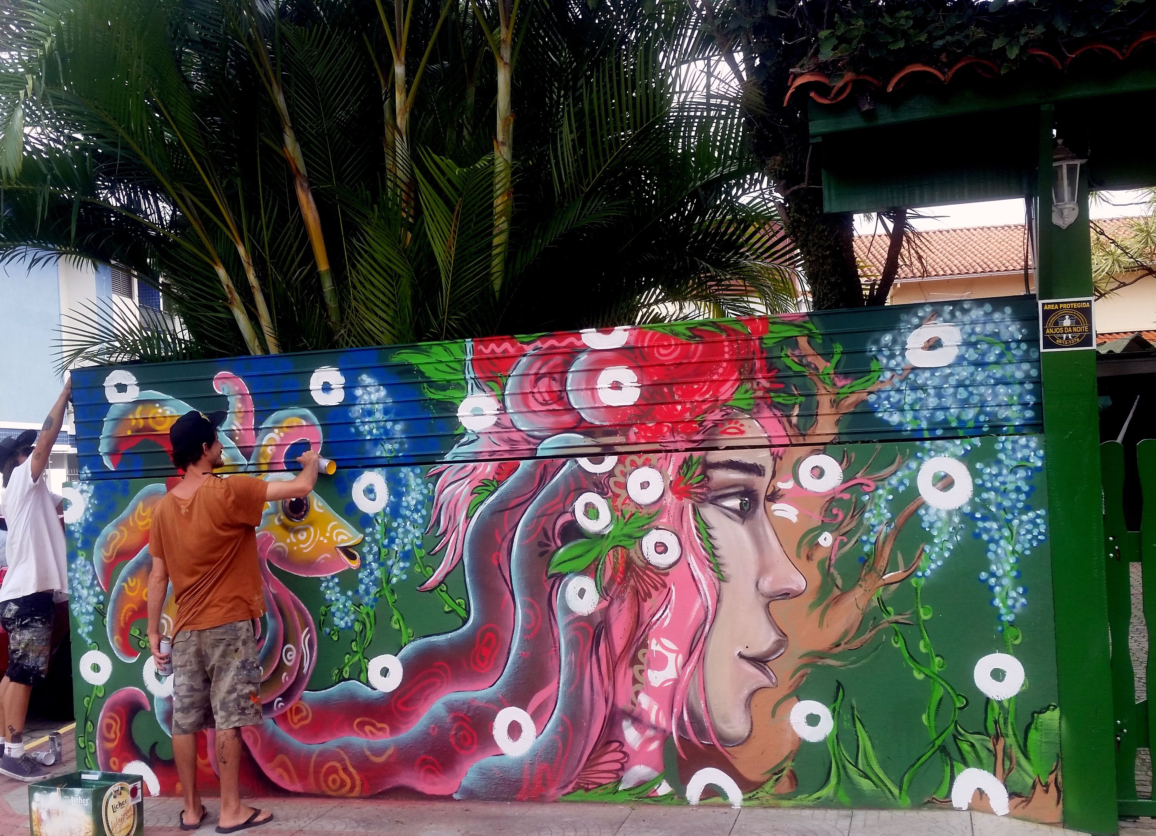 A mural painted on a wall with a large, colorful design featuring floral and abstract elements.