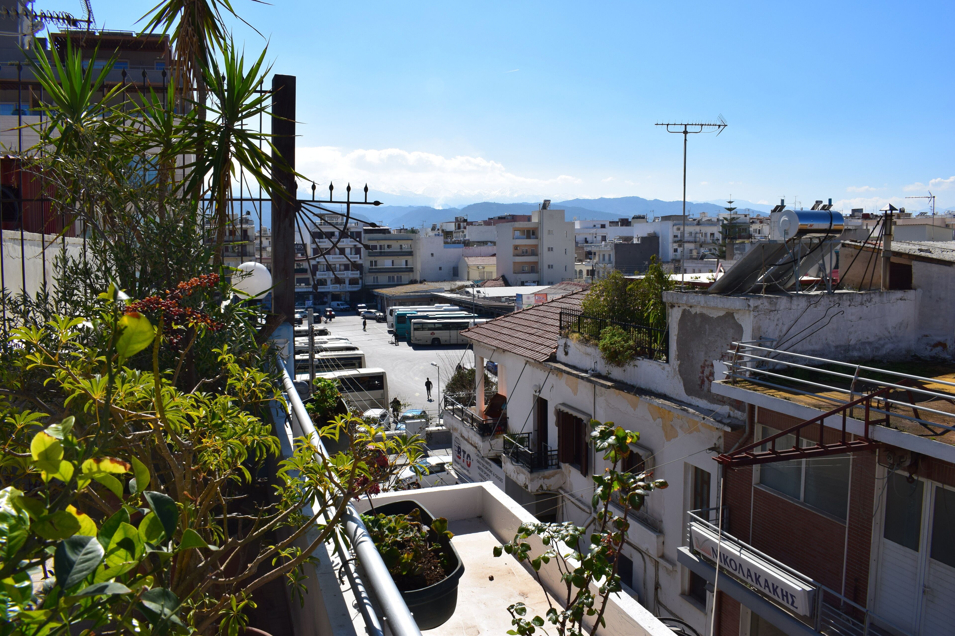 A view of a cityscape with buildings, a street, and a clear sky.