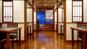 A traditional Japanese room with wooden flooring, tatami mats, and sliding doors. - Sapporo’s Secret Onsen Sanctuary Marukoma Onsen Ryokan (Chitose)