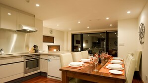 A modern kitchen with a dining area. - Holiday Niseko Cecuko (Kutchan)
