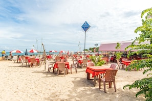 A beachside restaurant with outdoor seating and a view of the sea. - The Waves Unawatuna (Unawatuna)