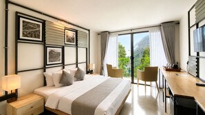 A modern hotel room with a large bed, a desk, two chairs, and a balcony with a scenic view. - Onrock Boutique Hotel (Ella)