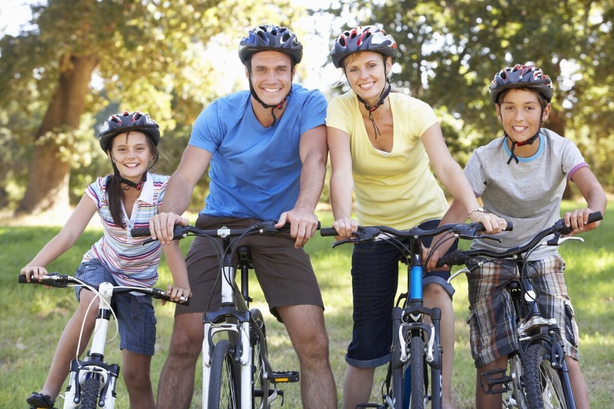 A group of people on bicycles in a park.