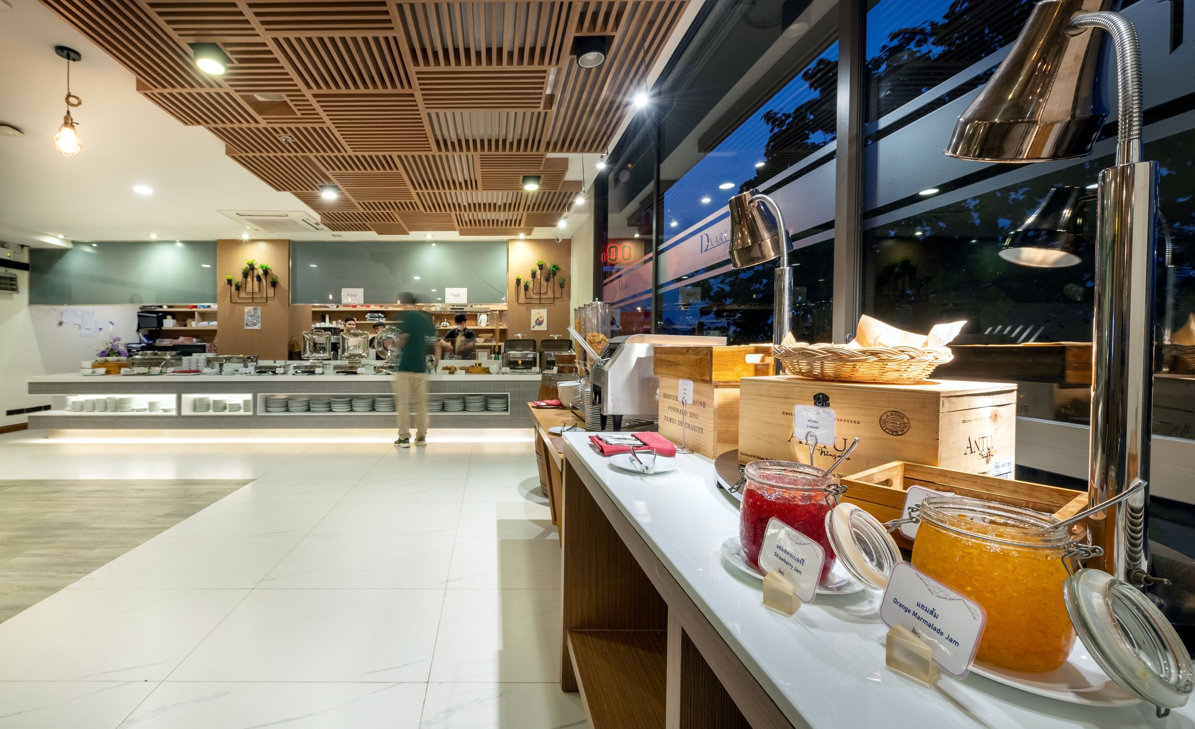 A buffet area with a variety of food items and a counter with a coffee machine.