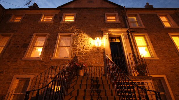 A stone building with multiple windows and a central entrance. - Inglestone House (Kelso)