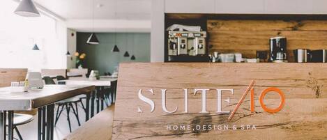 A modern kitchen with a wooden counter displaying the text "SUITE40 HOME, DESIGN & SPA".
