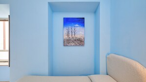 A room with a bed, a window, and a painting of a landscape. - Albergo della Posta (Bracciano)