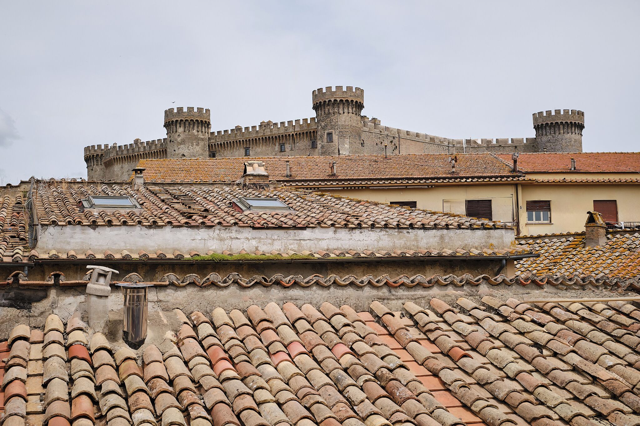 A historic building with a tiled roof and two towers.