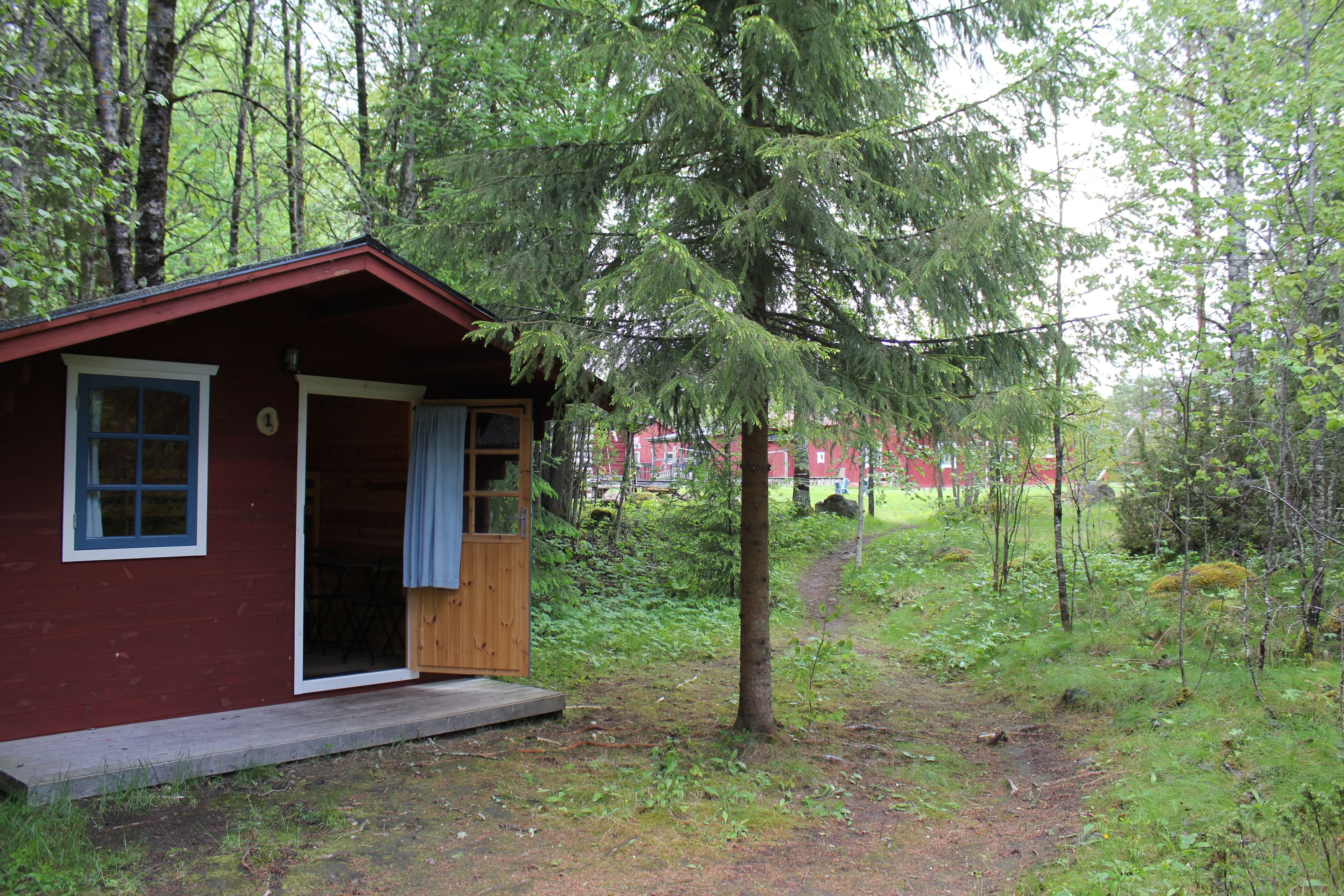 A small cabin with a wooden exterior, a single door, and a small porch.