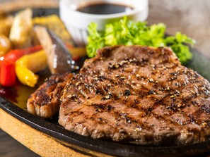 A grilled steak with vegetables and a small bowl of sauce. - HOTEL MYSTAYS Kagoshima Tenmonkan (Kagoshima)