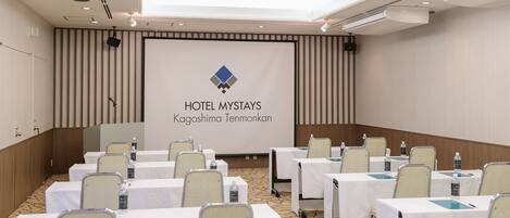 A conference room at Hotel Mystays in Kagoshima Tenmonkan with tables set up for meetings.