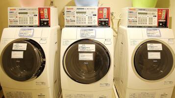 Three front-loading washing machines with control panels, each labeled with different brands and models.