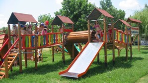 A playground with multiple play structures including slides and climbing areas.