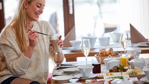 A breakfast setting with a variety of food items and beverages on a table. - Boutique Hotel Herzhof Garni - Apartments (Mittelberg)