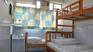 A bunk bed room with a desk and a window with curtains. - DormHK (Kowloon)