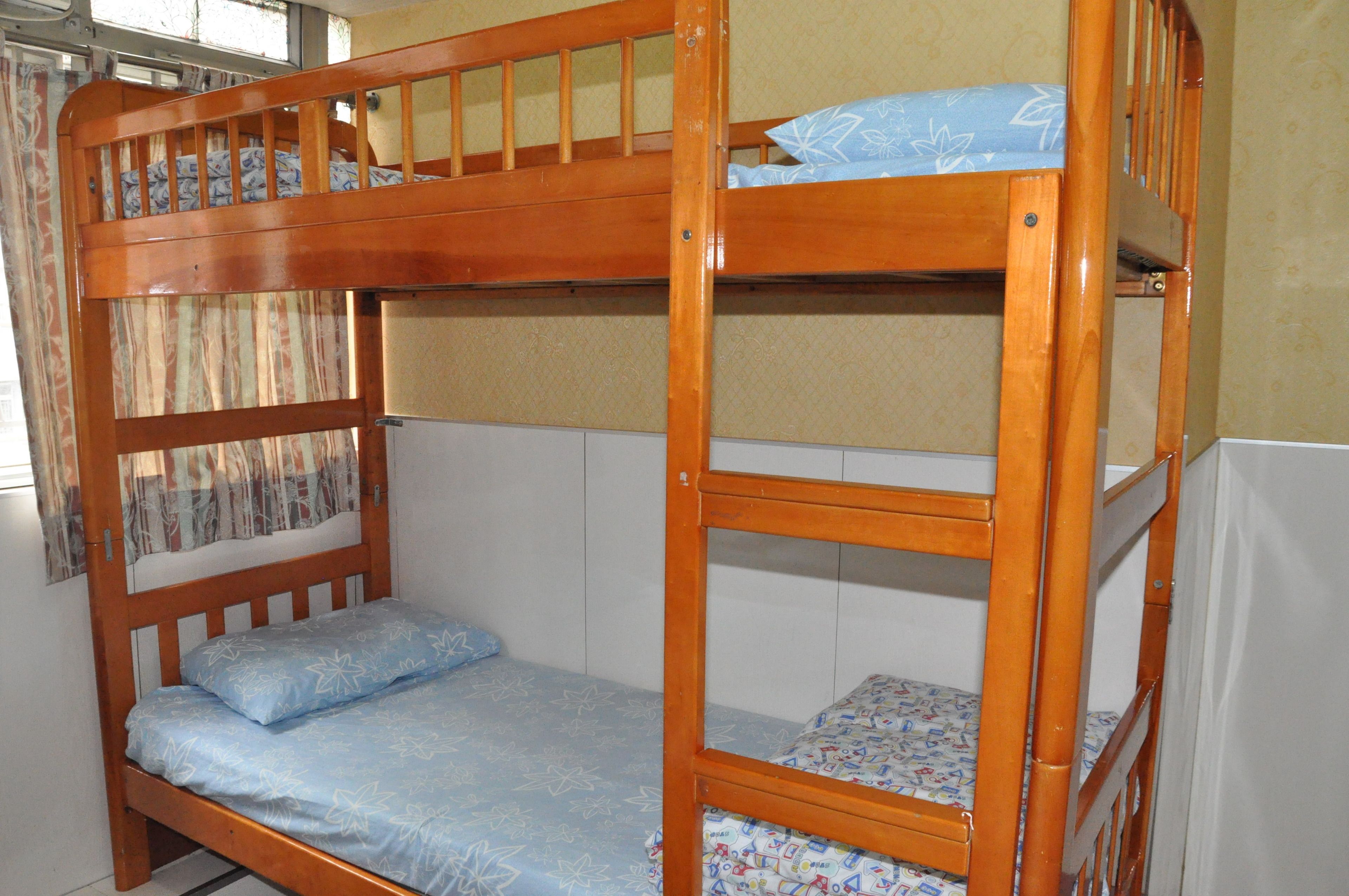 A bunk bed with a lower bunk and a mattress with a floral pattern.