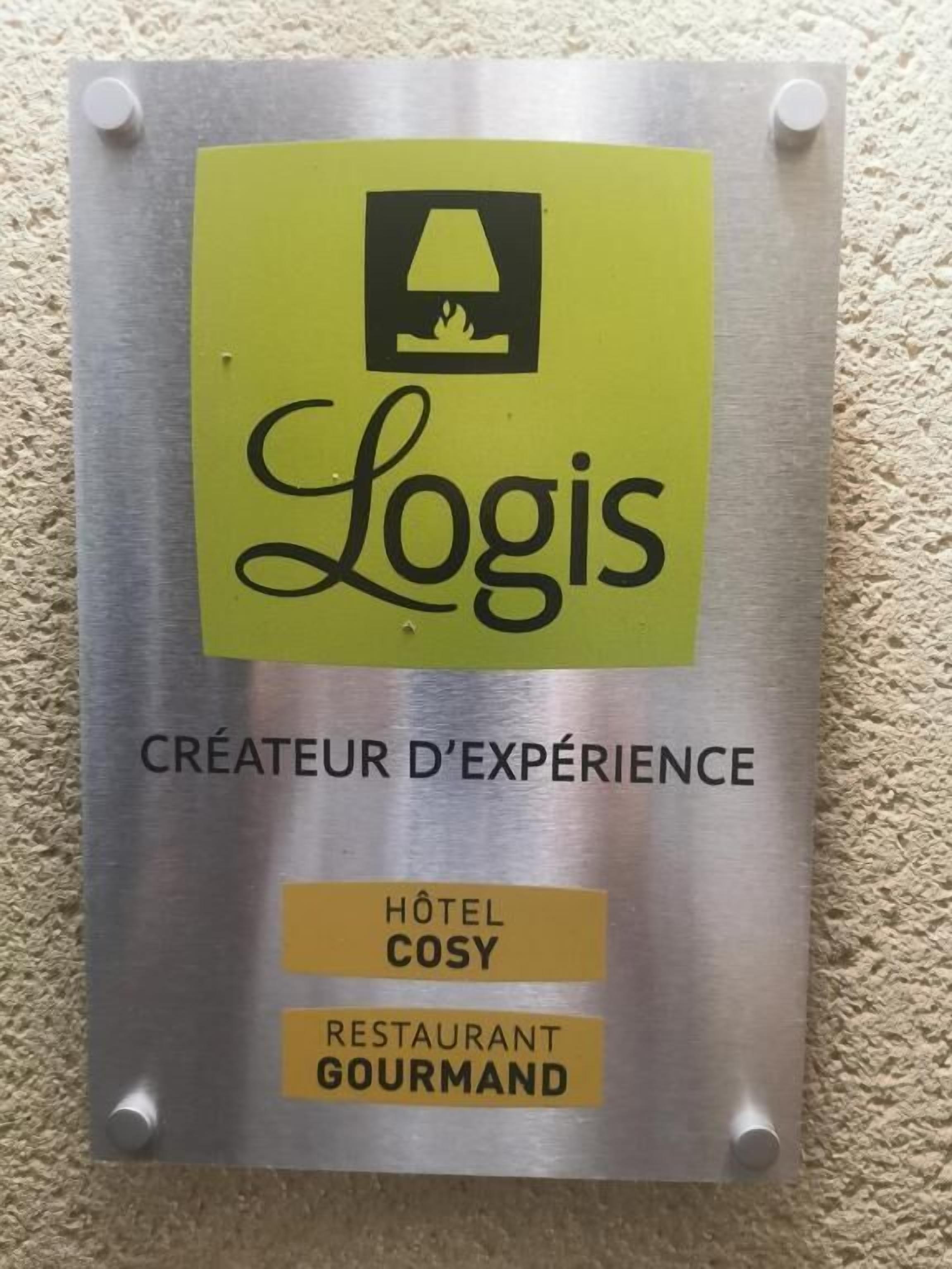 A sign with the Logis logo, indicating it is a creator of experiences, and mentions a hotel and a restaurant.