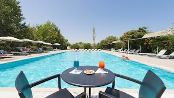Seasonal outdoor pool, pool umbrellas, pool loungers