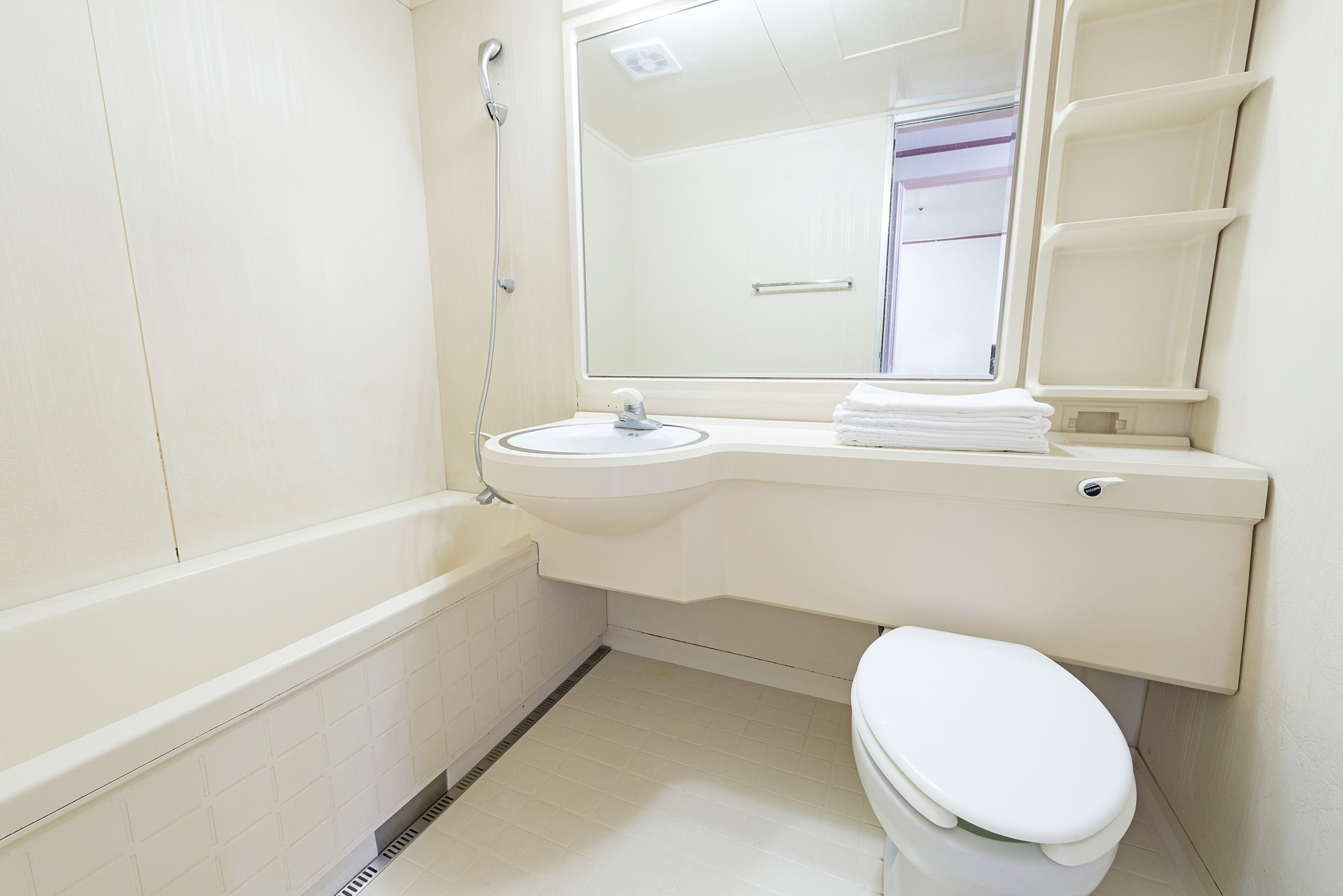 A bathroom with a bathtub, sink, and toilet.