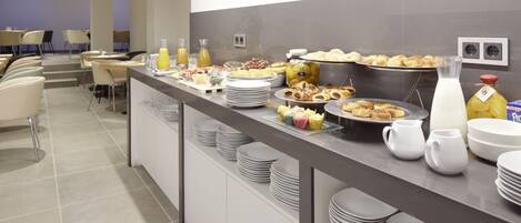 A buffet setup with various food items and beverages.