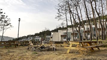 A campground with picnic tables and a street lamp.