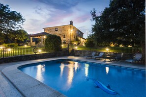 Een seizoensgebonden buitenzwembad en parasols bij het zwembad