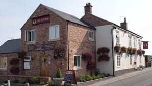 A traditional brick building with a sign reading "The Sun Inn." - The Sun Inn (Ellesmere)